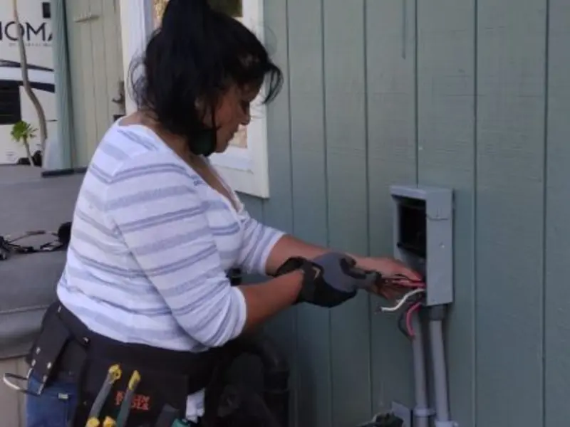 Licensed electrician wiring an exterior subpanel in Lakeland Village